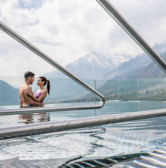 Couple in swimming pool embrace