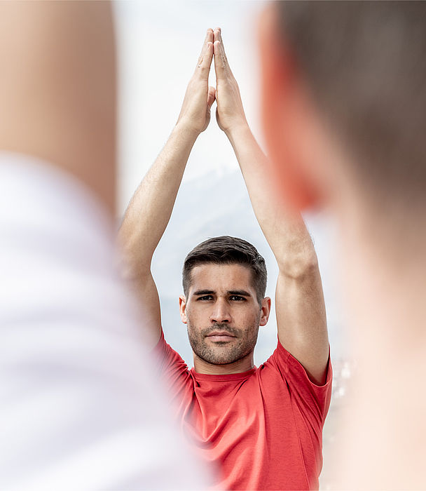 Man in red t-shirt doing yoga